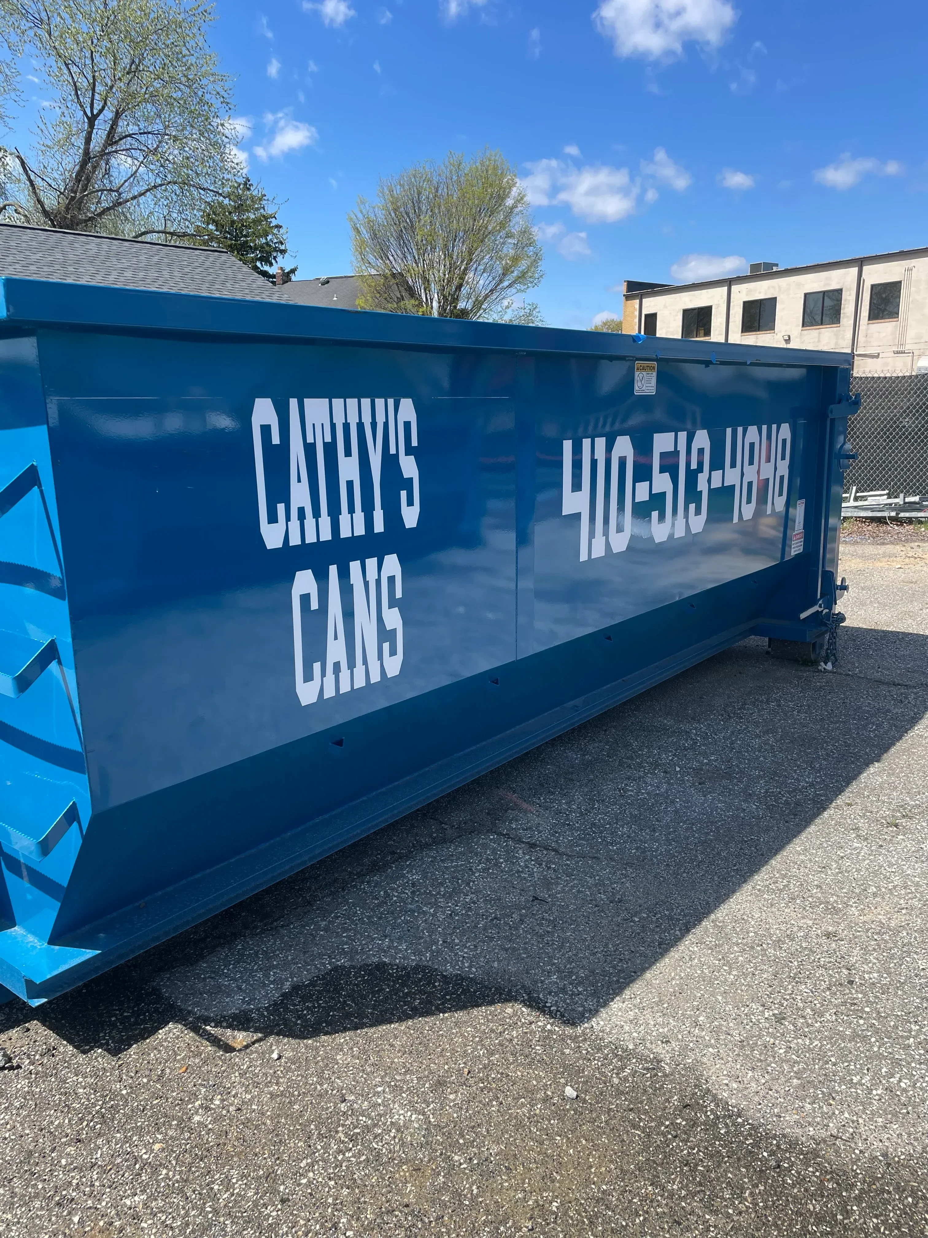 20-yard blue dumpster with white lettering on concrete surface